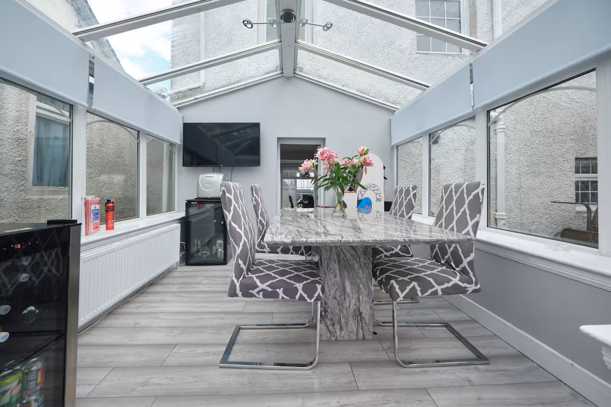 Bright glass conservatory dining area